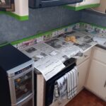 Half the job is to mask off areas before starting to paint the galley backsplash.